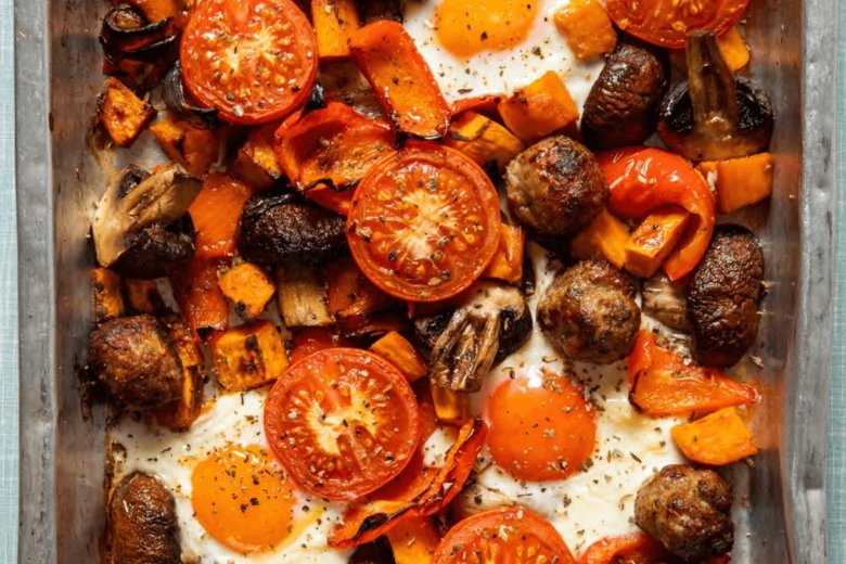 A Breakfast traybake inspired by the Hairy Dieters—a sheet pan filled with baked eggs, tomatoes, mushrooms, potatoes, and red bell peppers. Simple healthy food that's seasoned and perfectly roasted for a delicious start to your day.